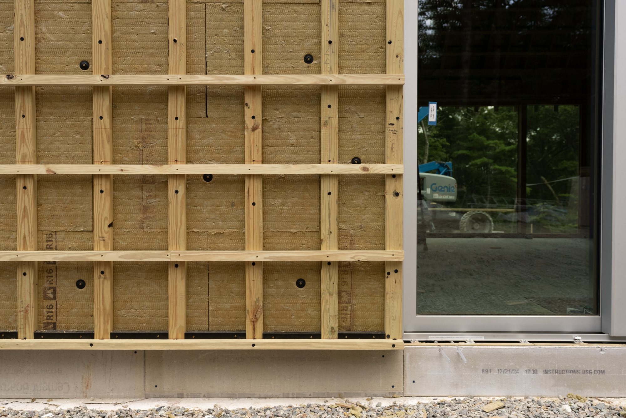 Vertical and horizontal strapping over the exterior mineral wool.