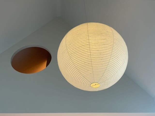 The Akari lantern beside the circular opening.