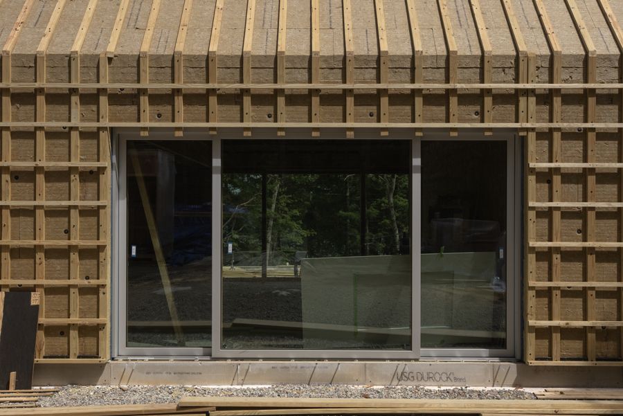 A lift-slide unit in the wall, before the shingle.