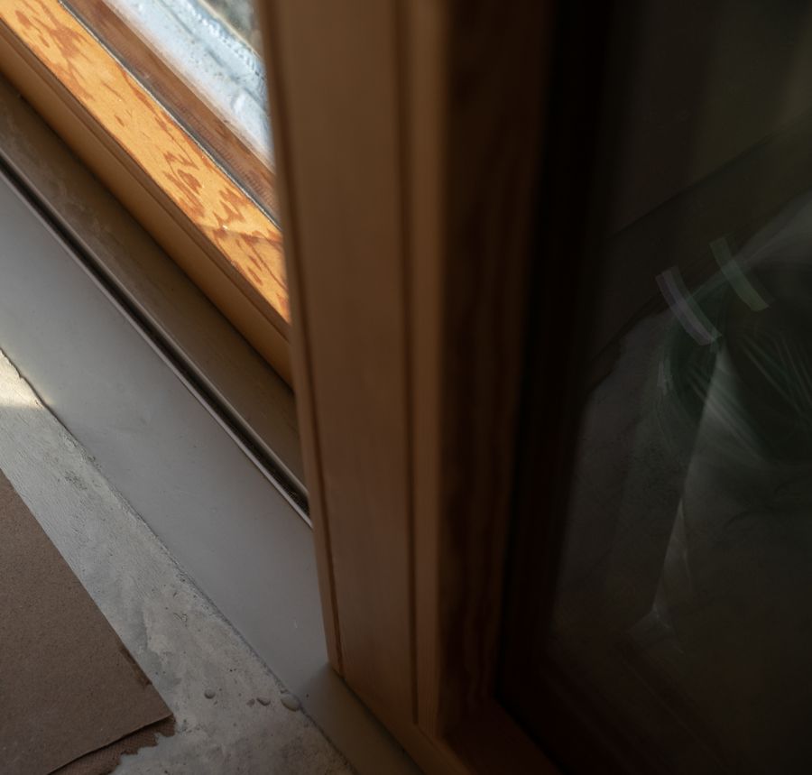 Where the wood lining meets the aluminum frame.