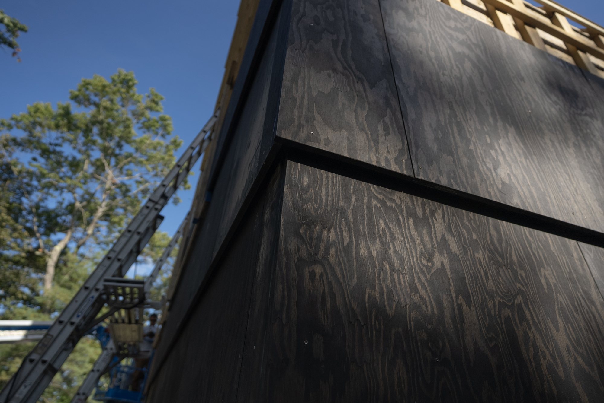 Pine-tarred megashingles at a corner. Each course laps the one below.