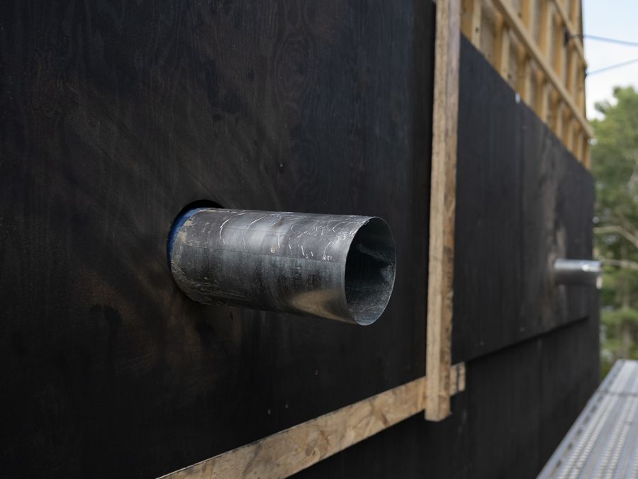 A duct passes through the shingle.