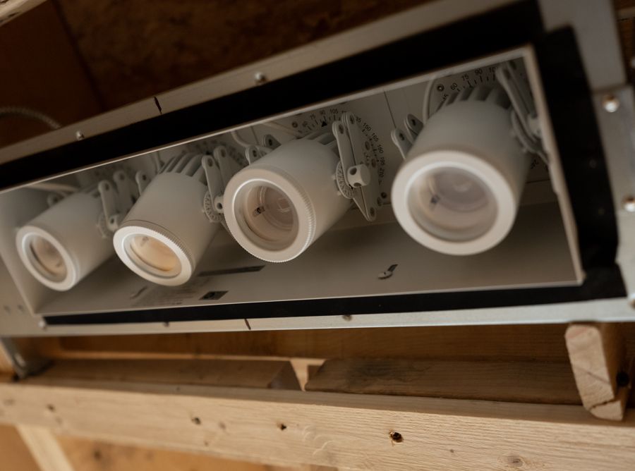 An adjustable recessed light before the ceiling is closed.