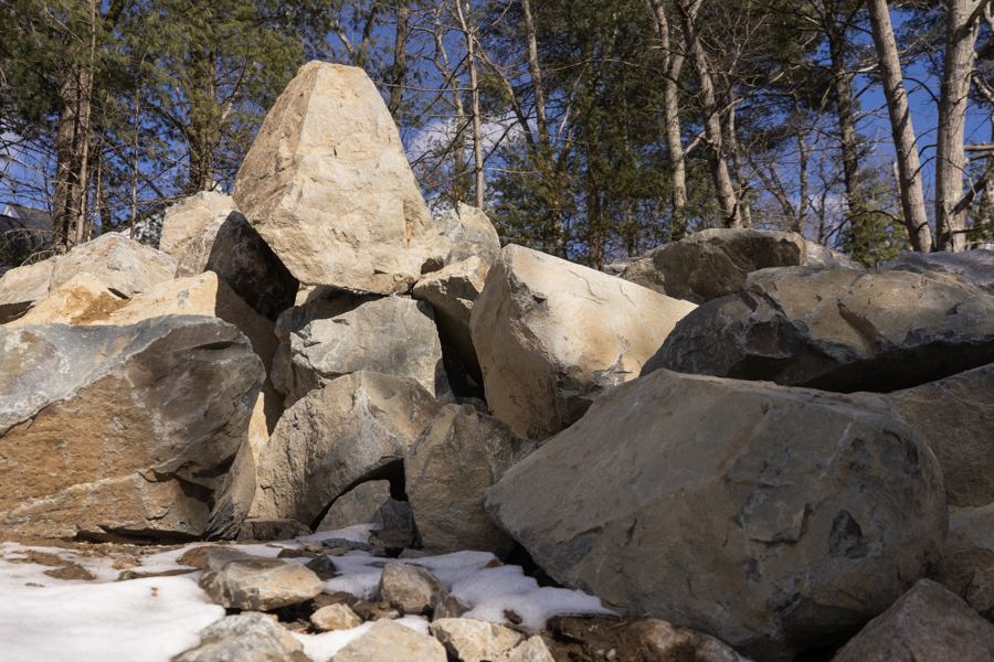 Blasted ledge, stacked at the edge of the site.