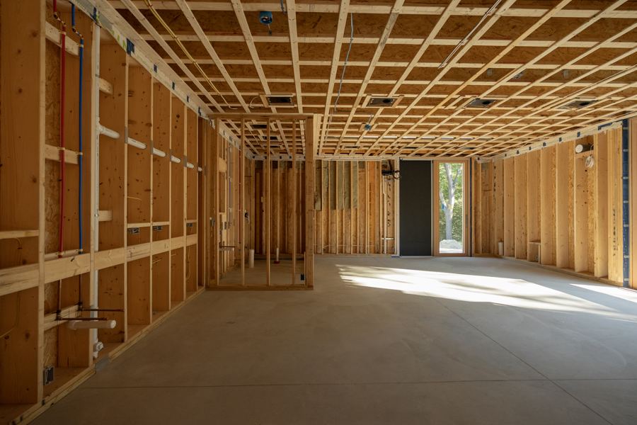 The first floor framed out, with strapping across the ceiling.