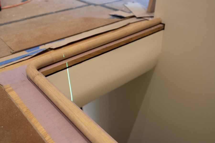 The handrail turning the corner of the stair.