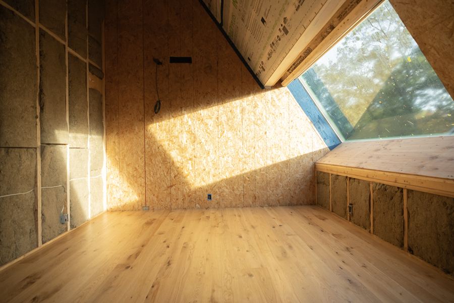 Sun from a roof window across the new wood floor.