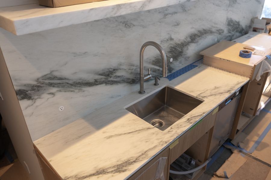 The stone counter and sink in the kitchen.