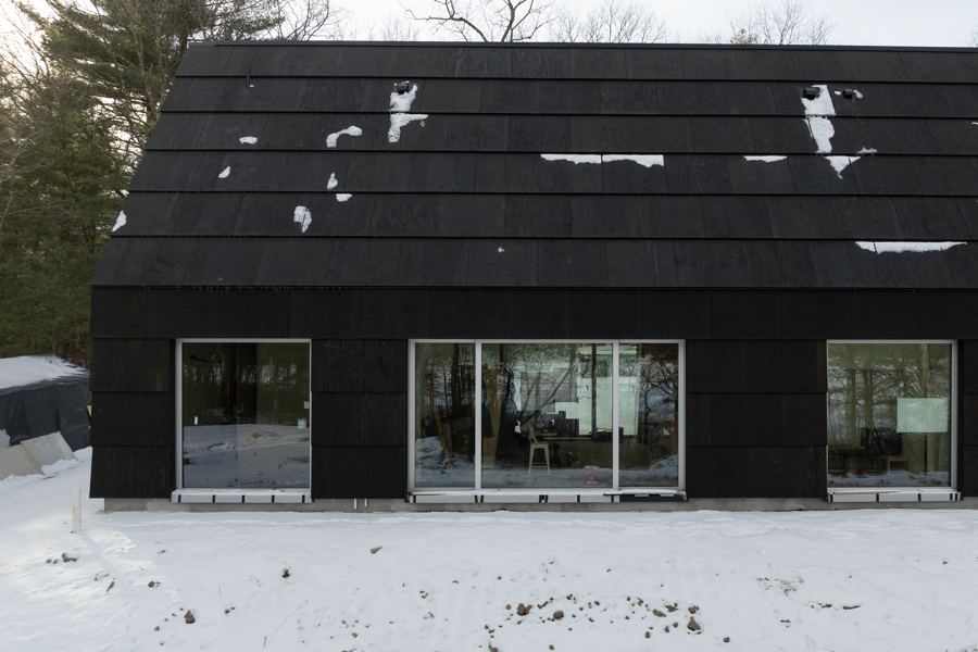 The long side of the house in snow.